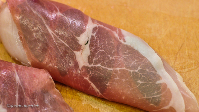 Wrap the prosciutto around the chicken breast; stake it in place with toothpicks.