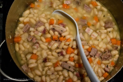 cooking beans, ham hock and pork belly for cassoulet