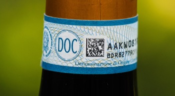The label is usually affixed up near the cork